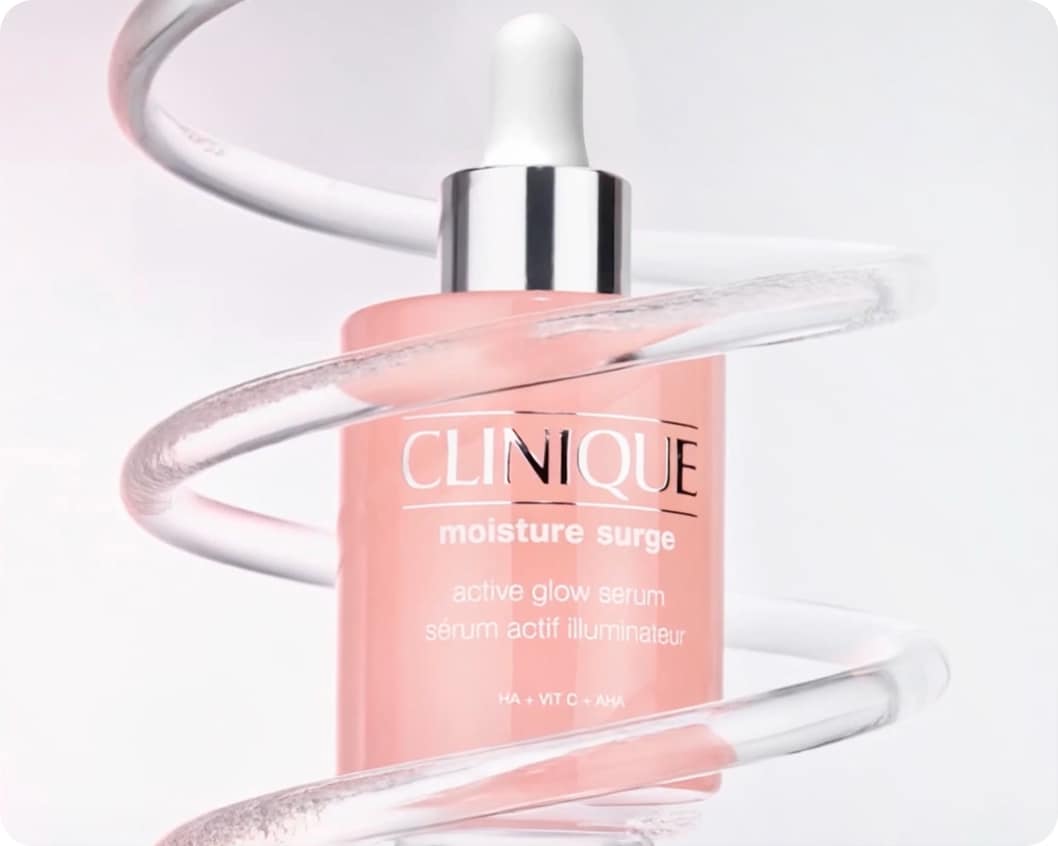 Close up of Moisture Surge Serum in front of animated lab glassware, in a brightly lit setting